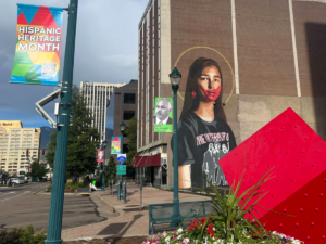 Downtown street adorned with banners, mural, public art