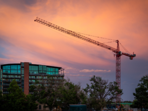 building and crane at sunrise