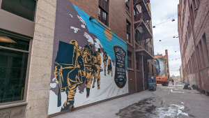 mural of climbers in alley