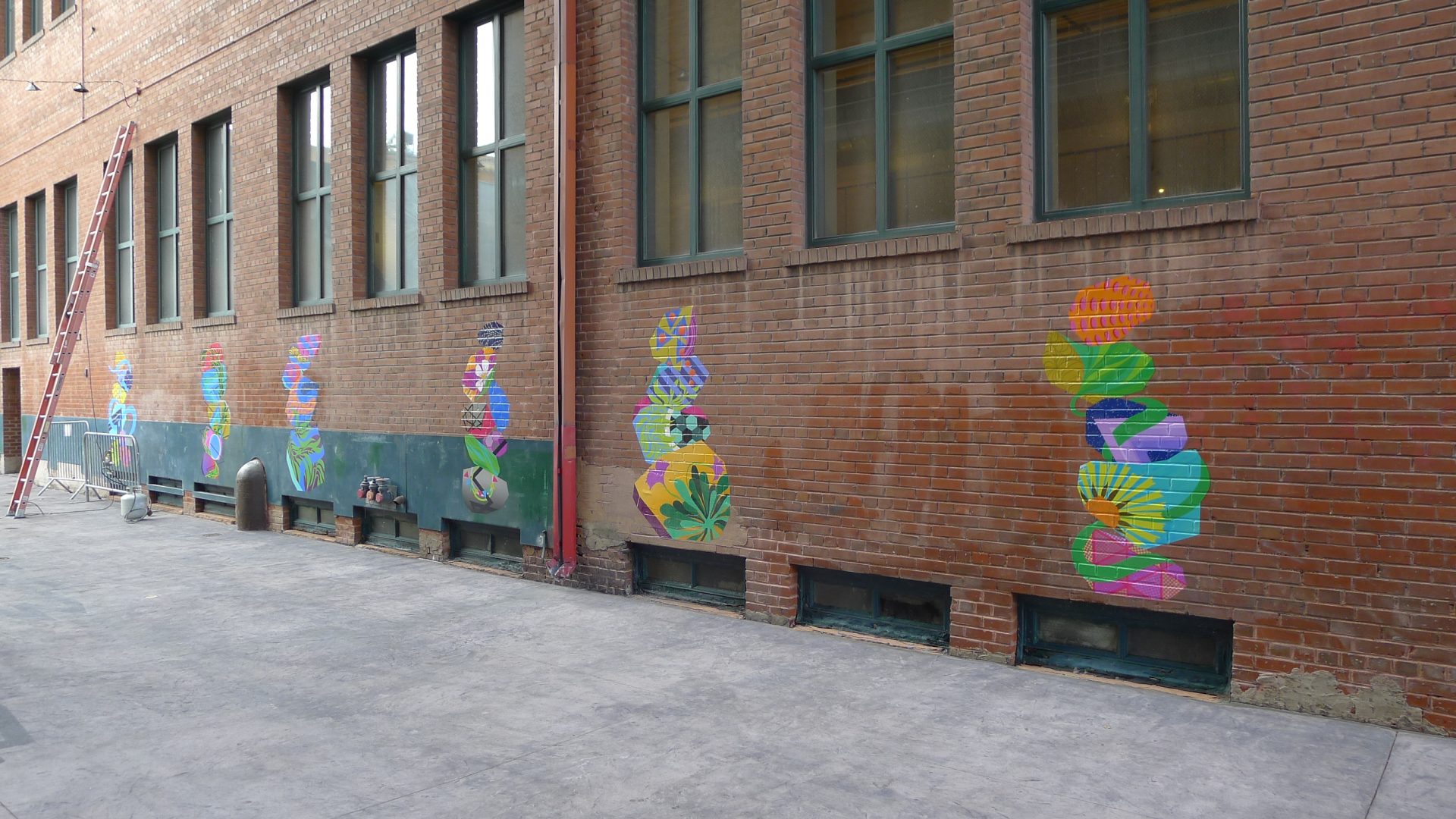 Colorful vinyl mural cairns in AdAmAn Alley